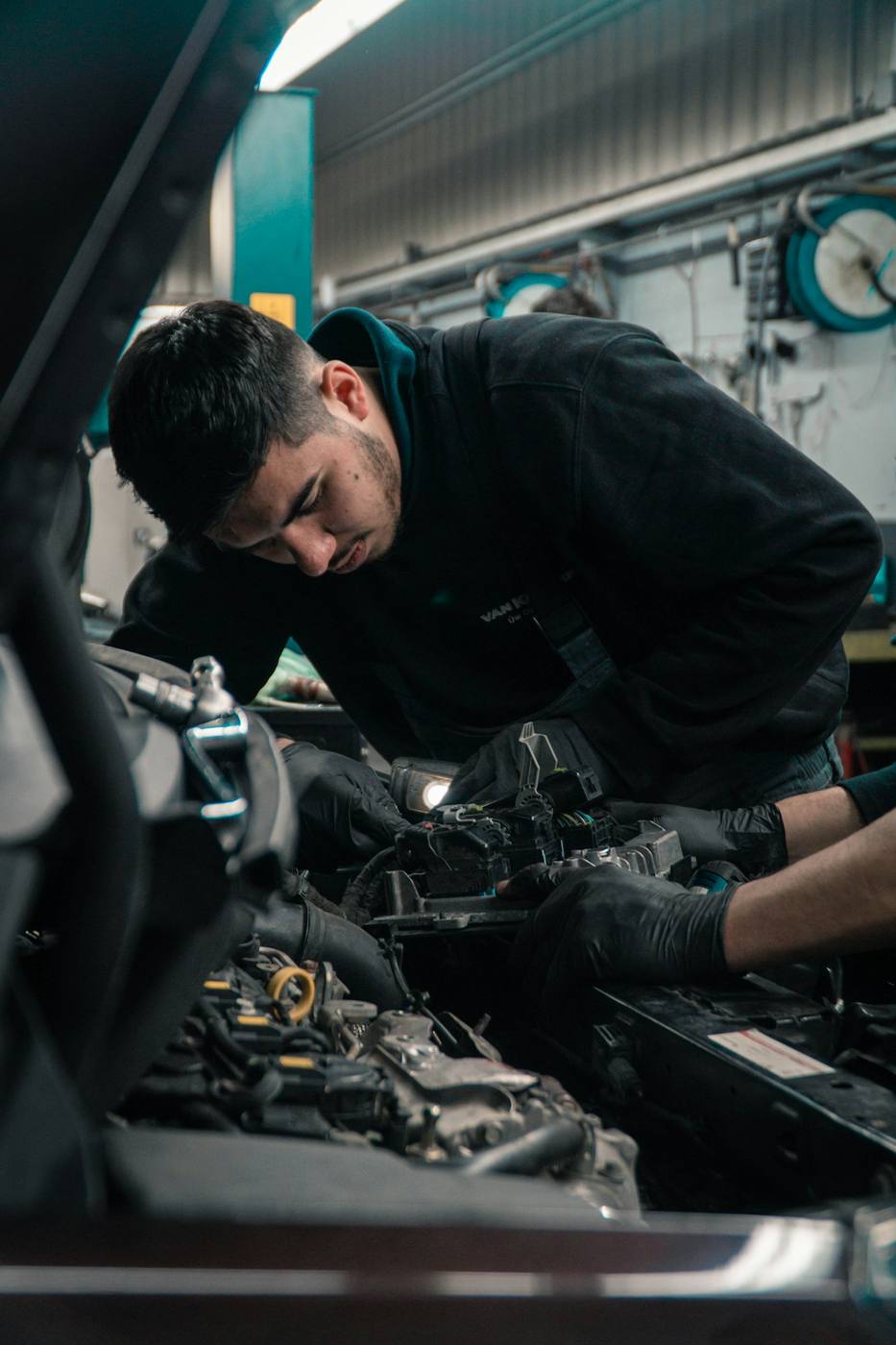 Technician at work in an automotive workshop — representative visual of hands-on craftsmanship